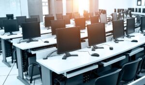 Group of computer neatly placed in a computer lab.