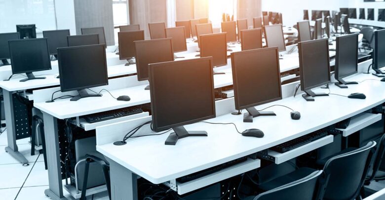 Group of computer neatly placed in a computer lab.